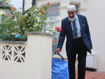 Picture of resident putting out his brand new paper and cardboard recycling sack