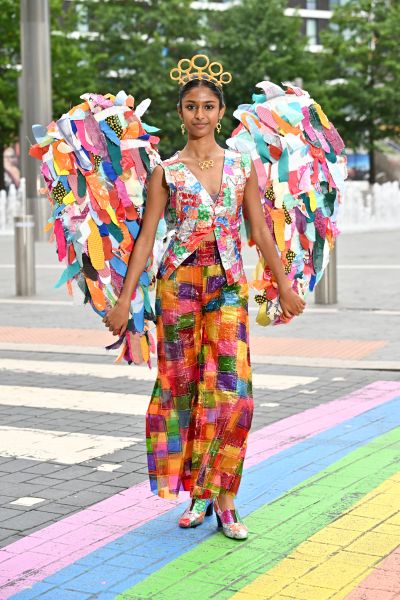 Model wearing bright junk kouture dress walking